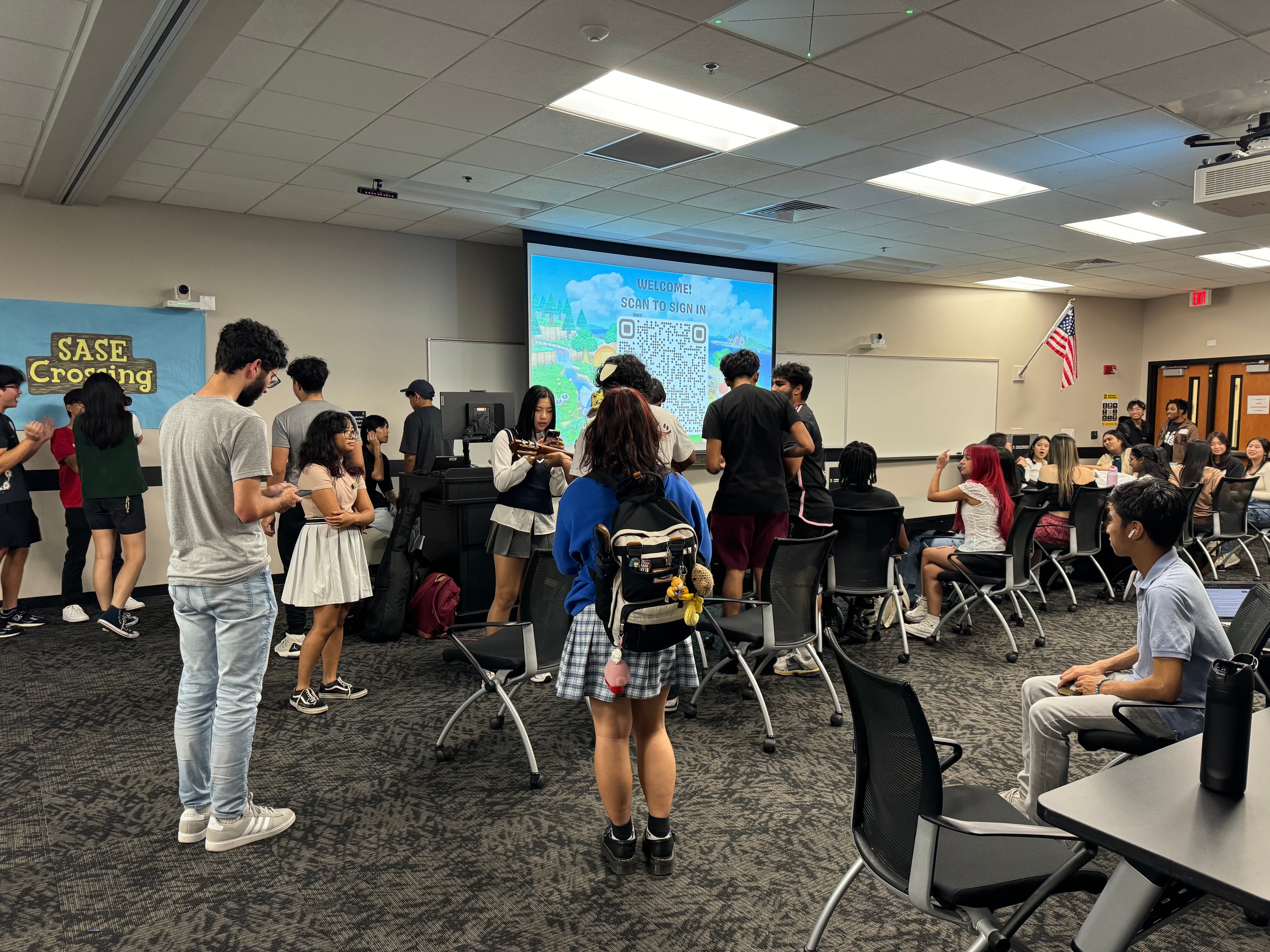 Members chatting and gathering for a SASE Crossing general body meeting