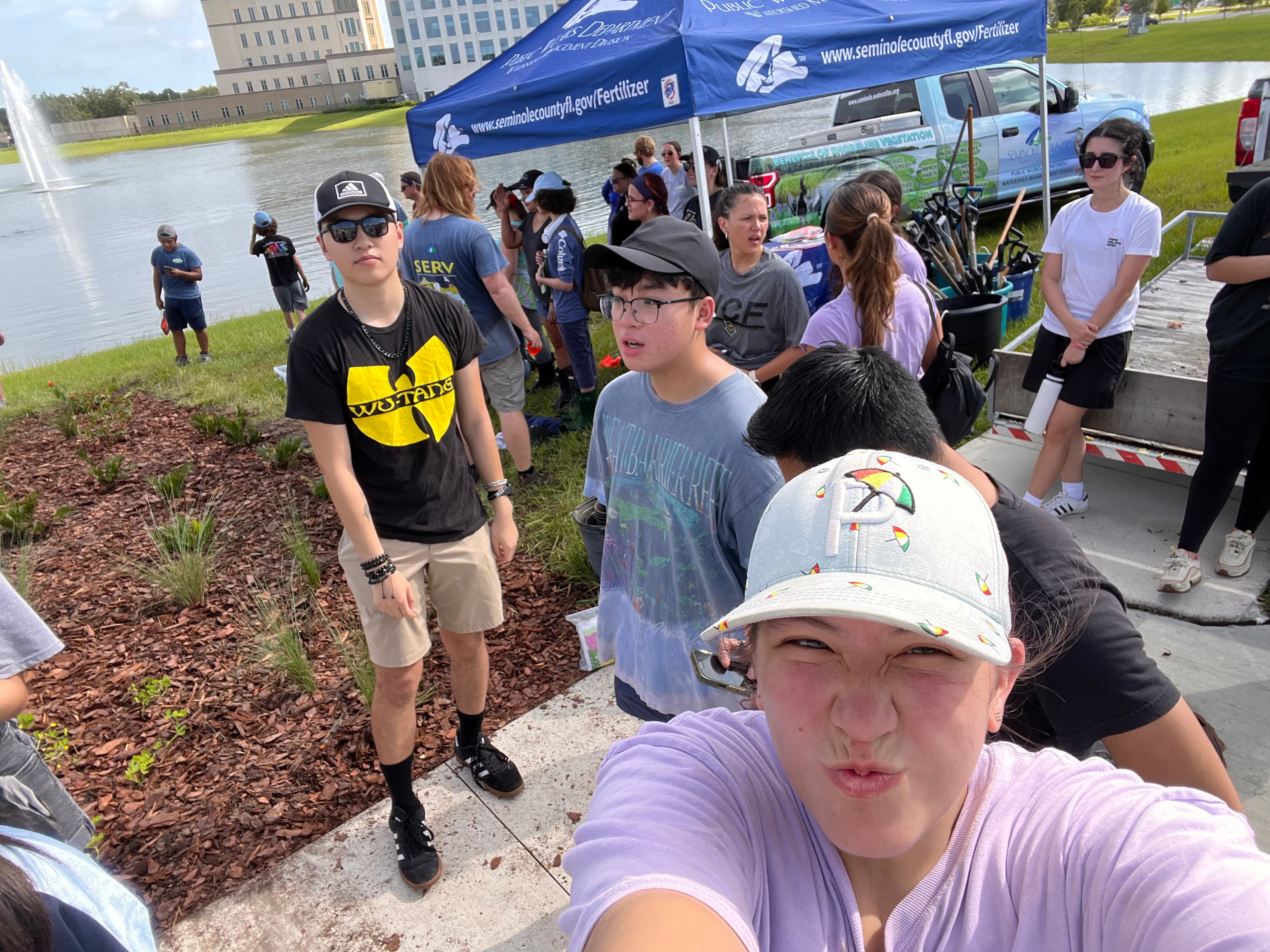 SASE members volunteering together beside the lake at Lake Lily